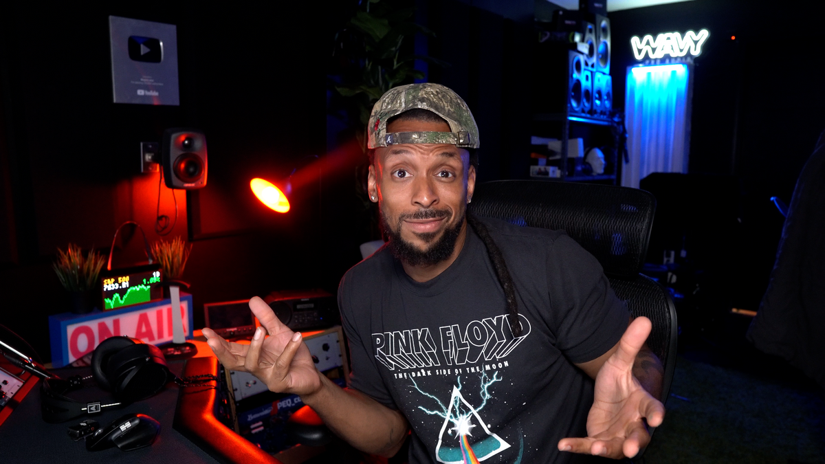 Wavy Wayne explaining audio techniques in his studio
